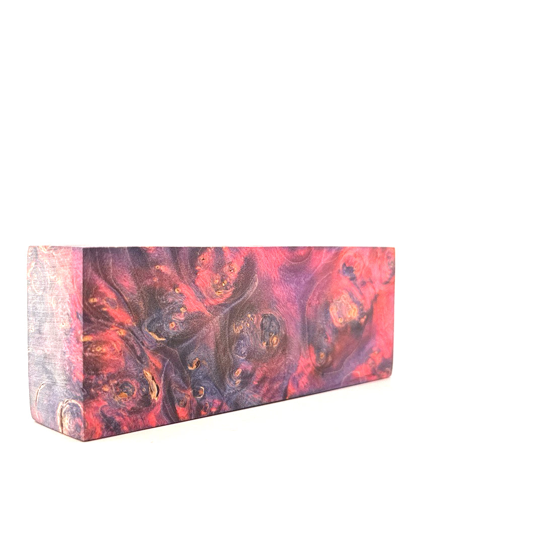 Rectangular block with a marbled design in red, purple, and gold on a white background