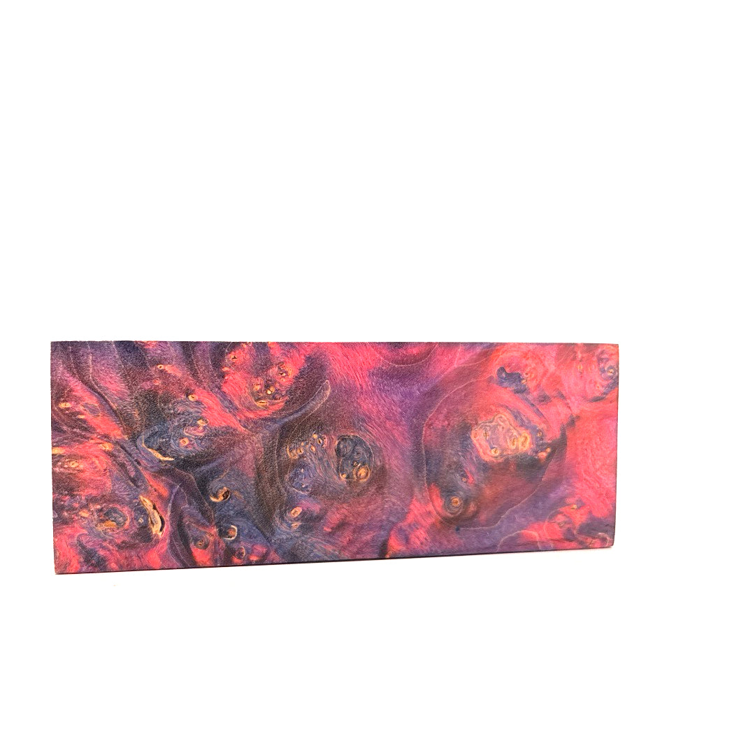 Rectangular mat with a swirling red, purple, and black pattern on a white background
