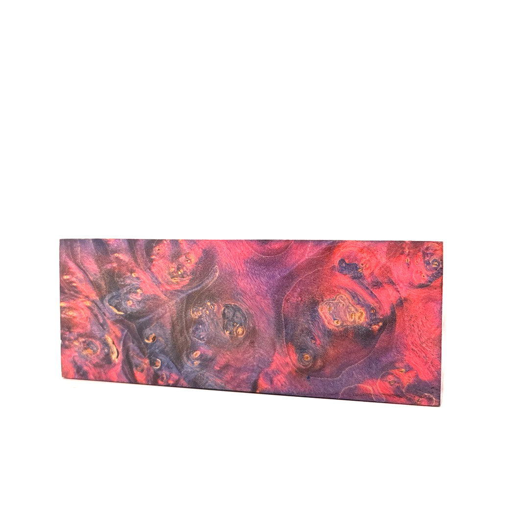 Rectangular piece of wood with a red and purple swirl pattern on a white background