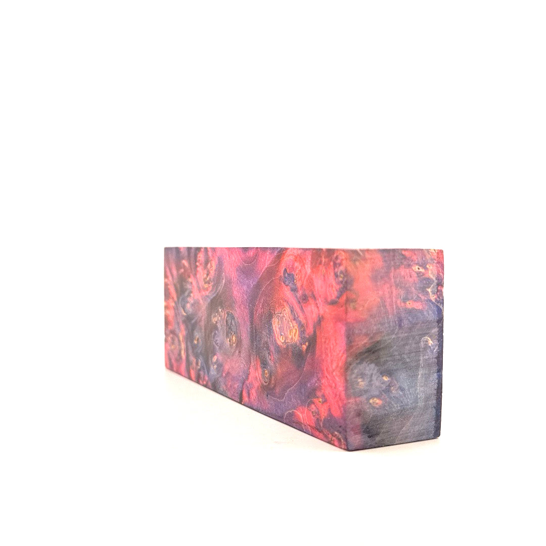 Wooden block with pink and purple marbled pattern on a white background