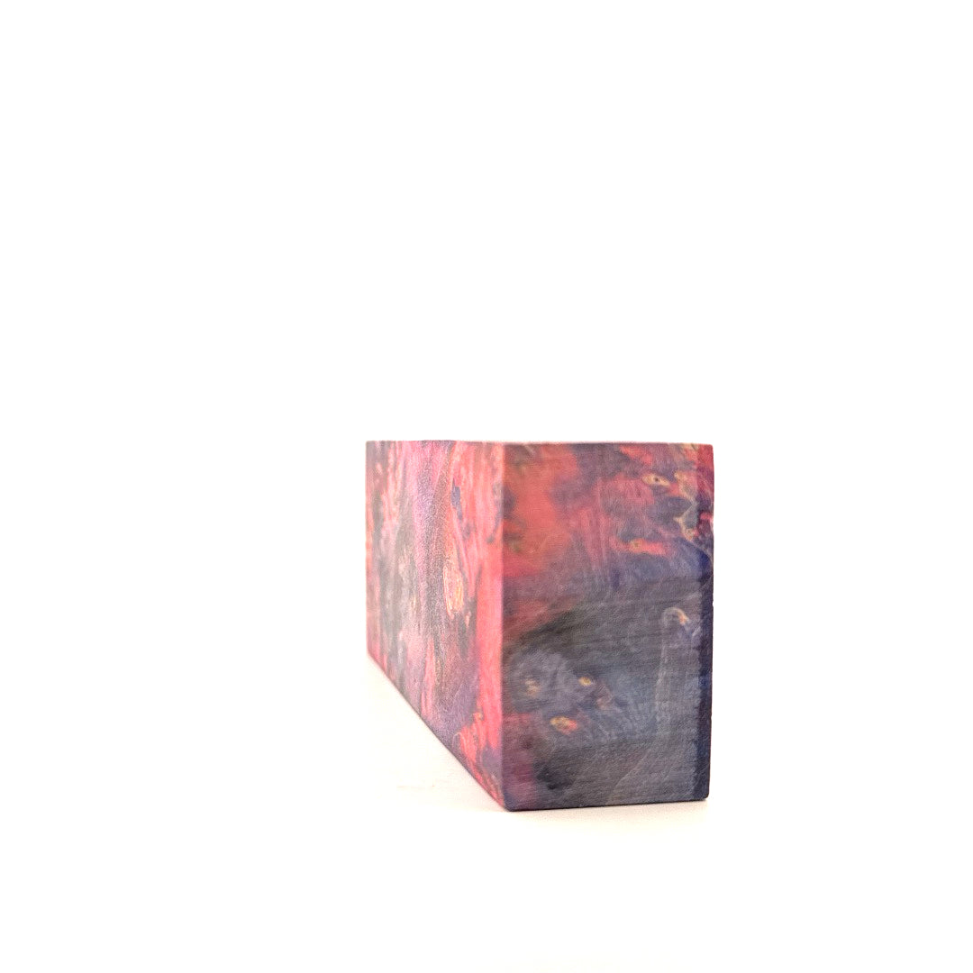 Rectangular wooden block with a multicolored finish on a white background