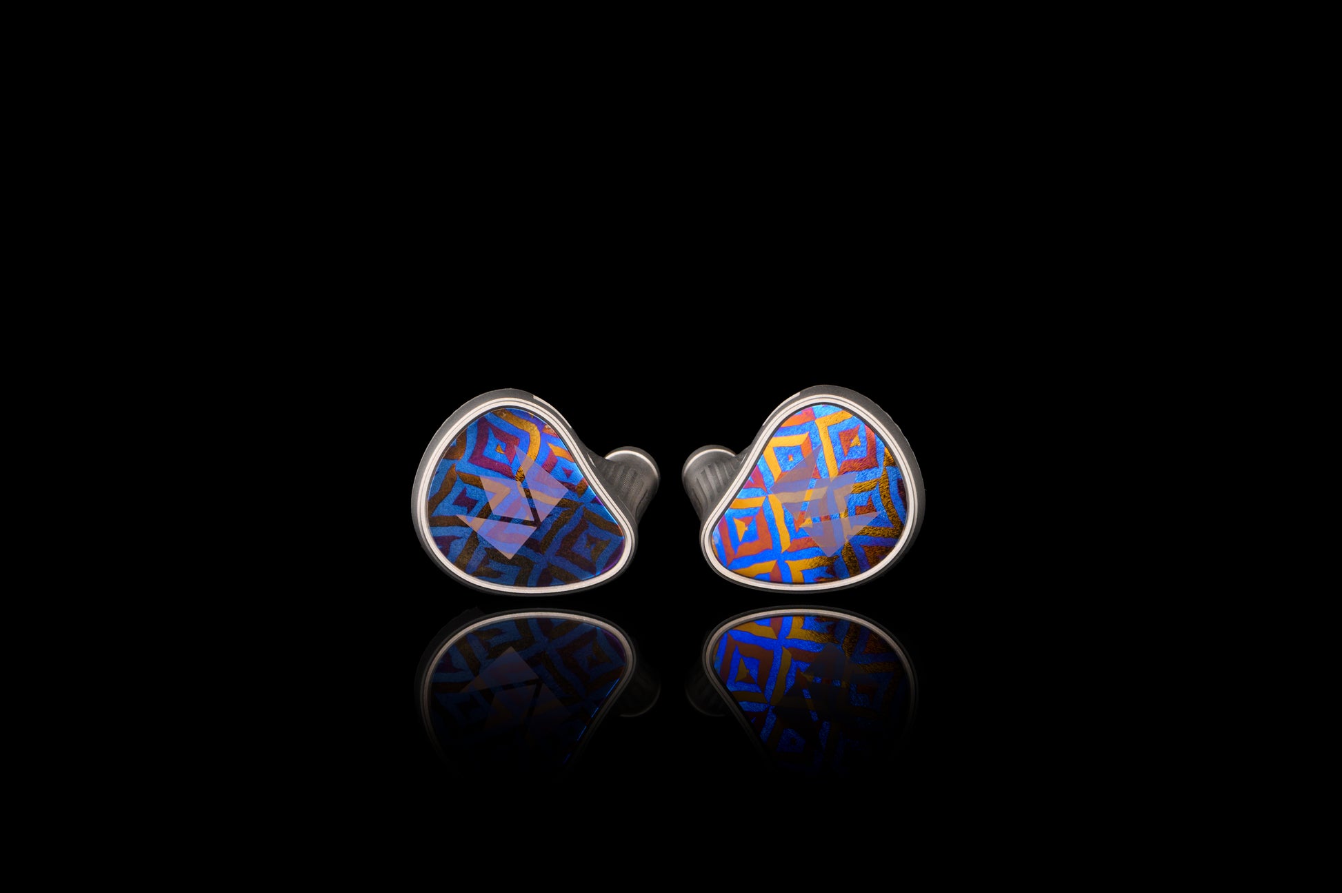 Kronos IEM's featuring diamond shaped geometric patterns on a blue background. Both sides feature the Noble logo. 