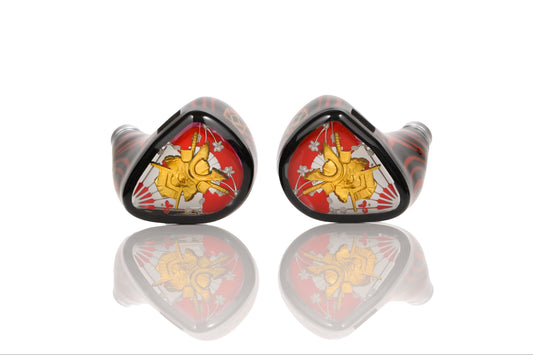 A pair of Shogun in-ear headphones with a striking red and black striped 3D-printed resin shell and detailed faceplate. The faceplate resembles a coat of arms with details heralding back to the samurai era. 