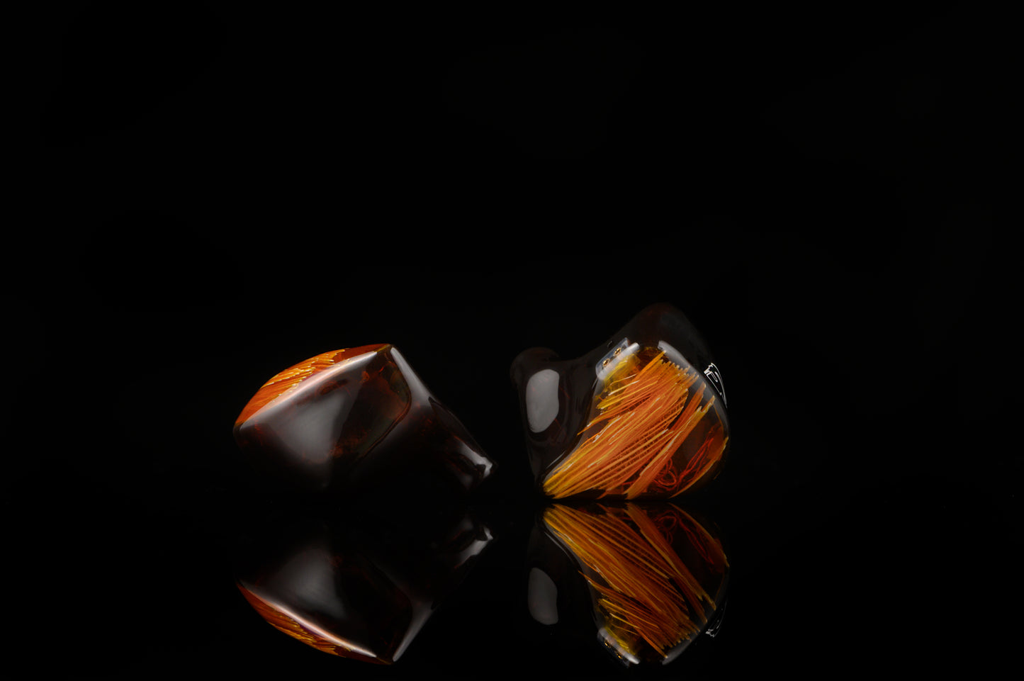 Spartakus IEM's featuring a red tinted wire mesh faceplate and shell.