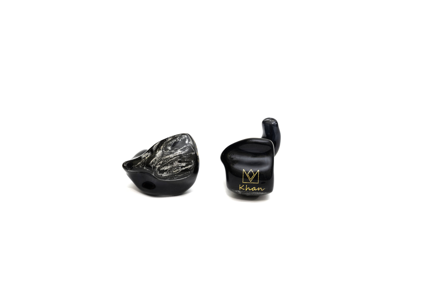 A pair of black custom in-ear monitors with a distinctive design, featuring a black and silver color scheme and a metallic finish. The right in-ear monitor is flipped and reversed to show a gold Noble logo and cursive "Khan" on a white background.